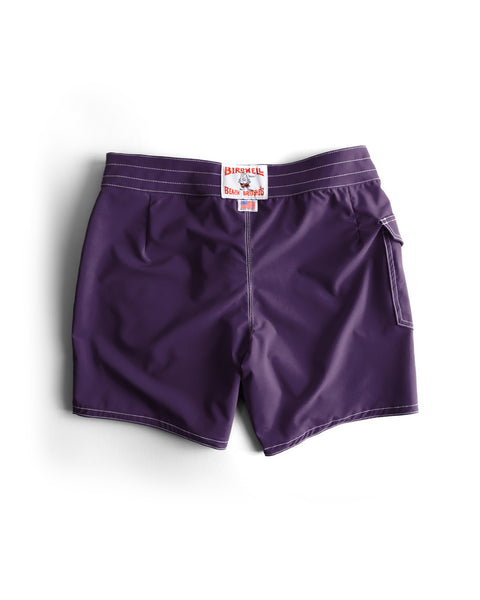 The 806 SurfStretch Side Pocket Boardshorts in purple feature white stitching, a right-side back pocket, and a white waistband label with red Birdwell Beach Britches text. Made in the USA.