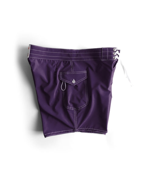 806 SurfStretch Side Pocket Boardshorts in purple, featuring white stitching, a flap front pocket with button, and white drawstrings on the waistband, displayed against a white background.
