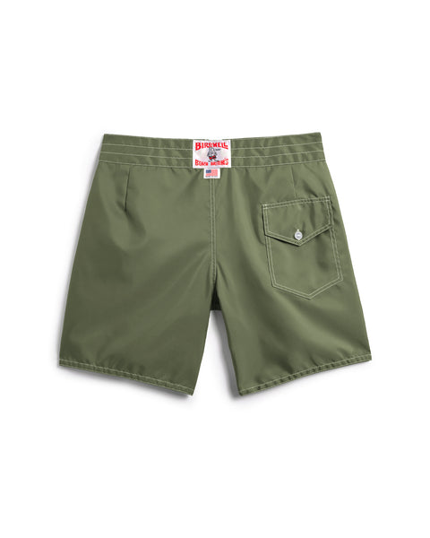 The 300 Boardshorts - Olive are shown from the back, featuring a single buttoned flap pocket on the right and a red and white Birdwell label above the waistband. Proudly made in the USA.