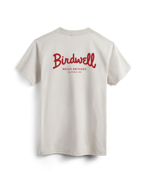 The Script Pocket T-Shirt - Cement is a light beige, garment-dyed tee with red 