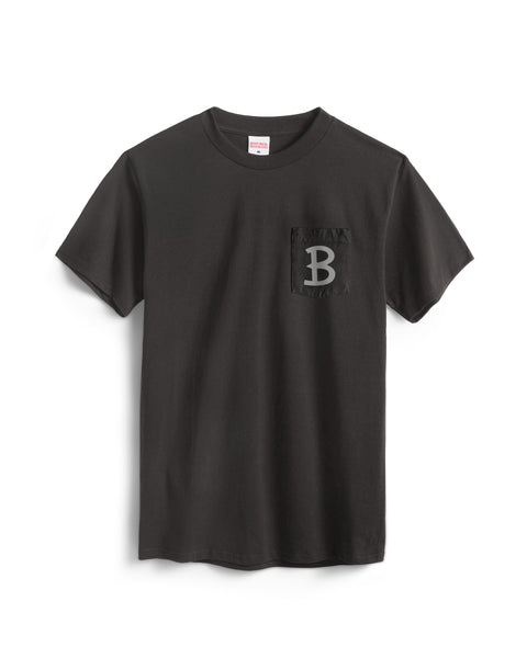 The Script Pocket T-Shirt - Vintage Black is a short sleeve black cotton tee made in the USA, featuring a large gray letter B on the left chest pocket.
