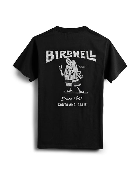 The 61 T-Shirt - Black is a heavyweight tee featuring a vintage cartoon surfboard graphic named Birdie and “BIRDWELL, Since 1961, Santa Ana, Calif.” text on the back. Garment-dyed for a soft, lived-in feel.