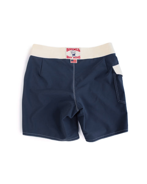 The 808 Mono Stripe boardshorts in Navy/Bone feature a white waistband, white stitching, a red and white back label, and a right-side pocket. These classic-inspired boardshorts are shown flat on a white background.
