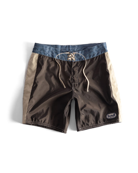 The 300 Legend boardshorts feature a brown front and back, federal blue waistband, bone side panels, lace-up closure, Birdwell patch on the left leg, and are proudly made in the USA.
