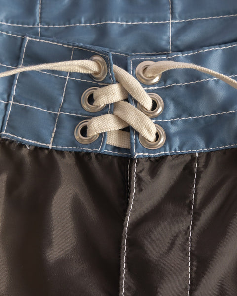 Close-up of the 300 Legend boardshorts in Brown/Federal Blue/Bone, highlighting the white drawstring threaded through silver eyelets. Proudly made in the USA.
