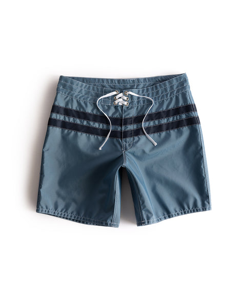 300 Comp Stripe boardshorts in Federal Blue/Navy, featuring a drawstring waist and two dark horizontal stripes, laid flat on a white background.
