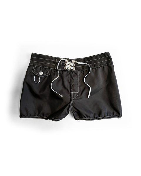 The 400 Boardshorts - Black are quick-drying women's boardshorts with white stitching, a lace-up front closure, and a buttoned side pocket, perfect for surf or swim. Displayed on a white background.