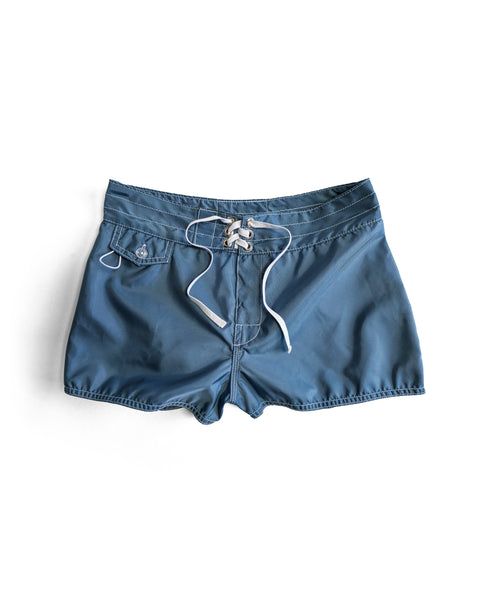 A pair of 400 Boardshorts - Federal Blue with a white drawstring and a small buttoned pocket on the left side, made in USA, laid flat on a white background.