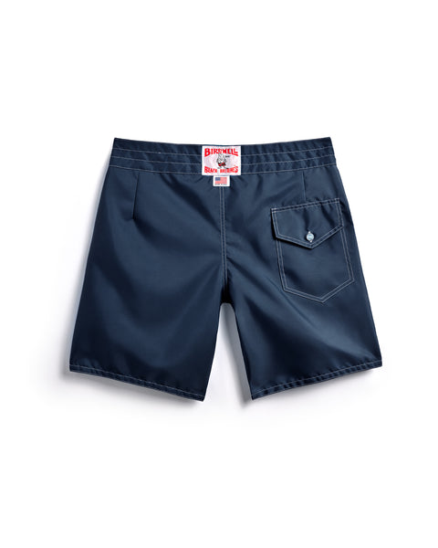 The 300 Boardshorts - Navy are shown from the back, with a right-side button-flap pocket and a red Birdwell label at the waistband. Water-repellent and made in the USA.