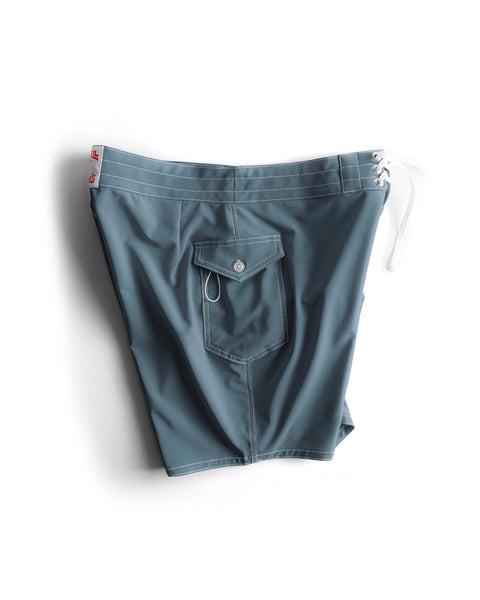 808 SurfStretch Side Pocket Boardshorts in Federal Blue, featuring a white drawstring, front waistband lacing, and a buttoned side flap pocket, shown laid flat on a white background.