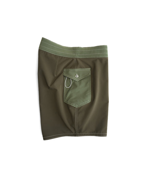 The 808 Pop Pocket boardshorts in Dark Olive/Olive, made in the USA, feature a button-flap back pocket with a metal key loop and are shown laid flat on a white background.