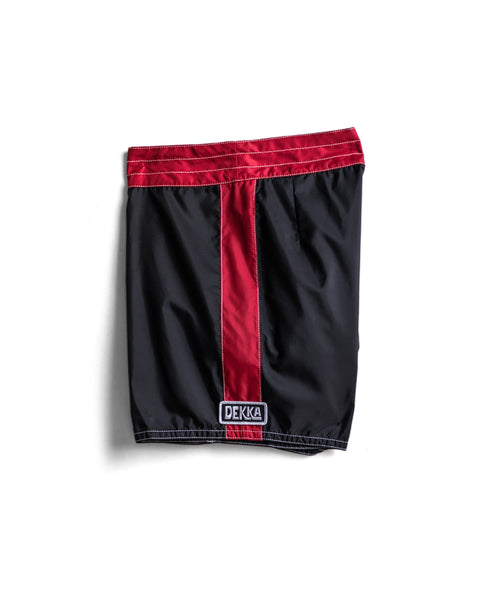 The 310 Dekka - Black/Red is a black and red nylon dog muzzle with a vertical red stripe, crafted from SurfNyl fabric. Features a DEKKA label at the bottom and is made in the USA.