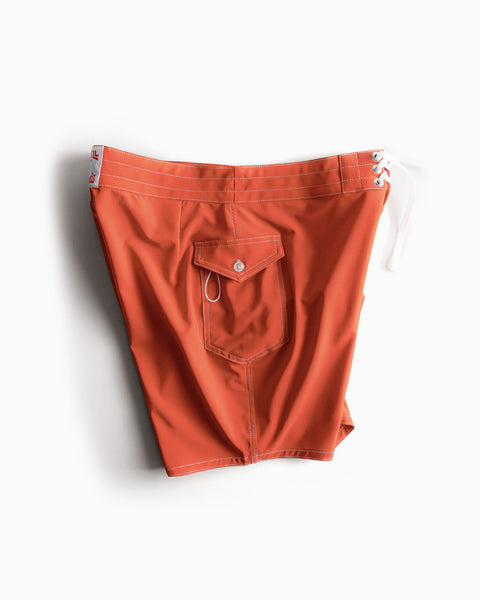 808 SurfStretch Side Pocket Boardshorts in paprika, featuring a buttoned back pocket, white contrast stitching, and a white lace-up side closure.