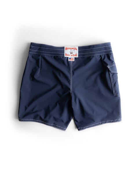 806 SurfStretch Side Pocket Boardshorts in navy, featuring white stitching, a right-side back pocket, and a red and white Birdwell label on the waistband; made in the USA and shown flat on a white background.