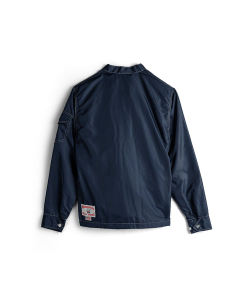 Racing Jacket 26 in Navy/Bone/Red is displayed from the back on a white background, featuring durable SurfNyl fabric, buttoned cuffs, and a patch near the bottom hem.