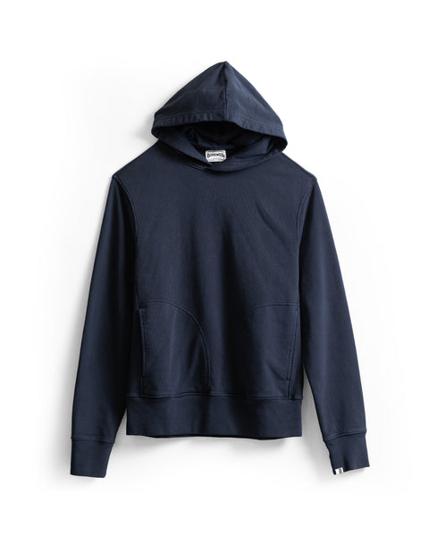 Introducing the Harmony Hoodie - Navy: a premium dark blue hoodie made from soft French terry, featuring long sleeves, a front kangaroo pocket, and a small white tag on the left cuff. Displayed on a white background. Proudly made in the USA.