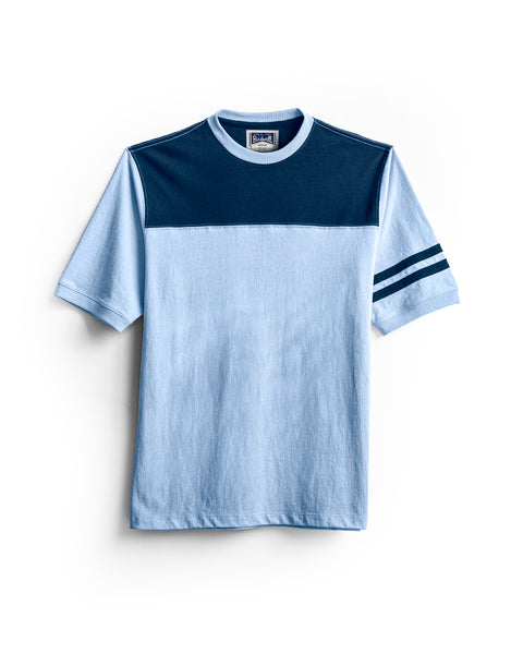 Introducing the Special Teez Champ in Arctic Blue/Navy: a premium short-sleeve t-shirt featuring an arctic blue body, a bold navy panel across the shoulders and chest, and two matching navy stripes on the left sleeve. Designed with a classic crew neckline and crafted from 100% cotton, this tee is showcased against a clean white background.