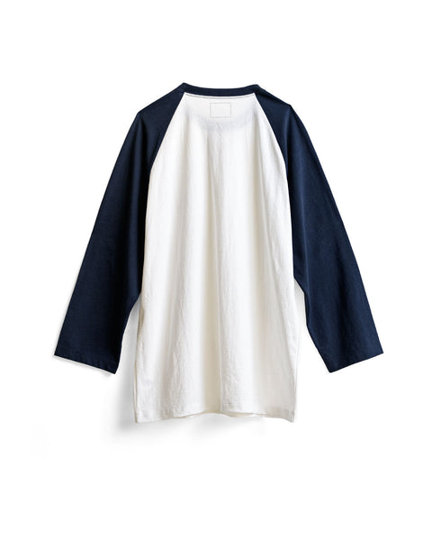 Introducing the Special Teez Pastime in Vintage White/Navy: a long-sleeved raglan t-shirt featuring vintage white front and back panels with contrasting navy sleeves. Crafted from soft, USA-grown cotton, this classic baseball-style shirt offers a relaxed fit for maximum comfort. Shown here against a white background.