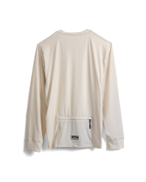 The Sunteez Long Sleeve - Bone is an off-white, long-sleeve UPF50+ shirt shown from the back, featuring a zippered pocket at the lower back with a small rectangular label beneath the zipper. Made from performance stretch fabric, this shirt delivers comfort and protection for active days.