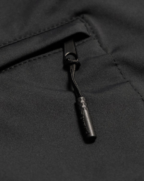 Close-up of a black zippered pocket on the Sunteez Long Sleeve, featuring a corded zipper pull with a textured grip. The smooth, slightly reflective fabric showcases the advanced moisture-wicking qualities and premium UPF50+ sun protection of this long sleeve shirt.