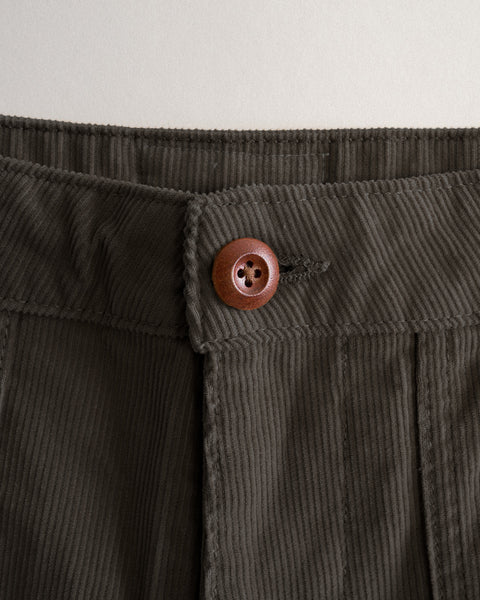 Close-up of the waistband of Classic Corduroy Pants - Brown, featuring a single dark brown button.