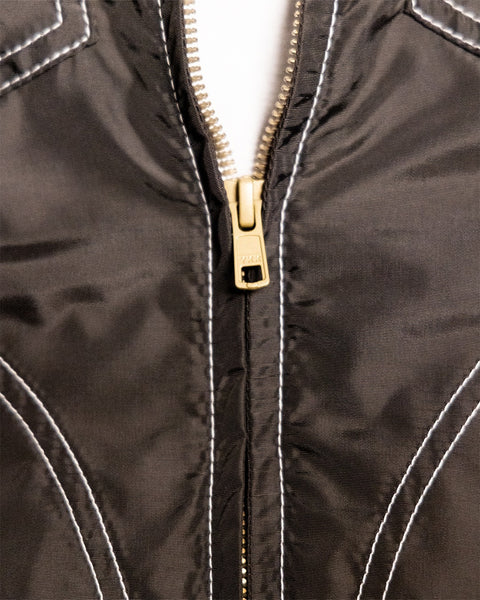 Close-up of a brown/acorn Capistrano Jacket with contrasting white topstitching.