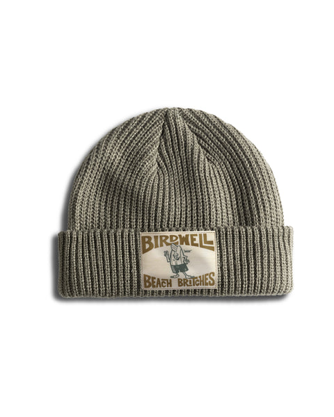Olive green, wide ribbed License Plate Watchcap - Eucalyptus fisherman beanie with a rectangular patch featuring a cartoon character and the text Birdwell Beach Britches.