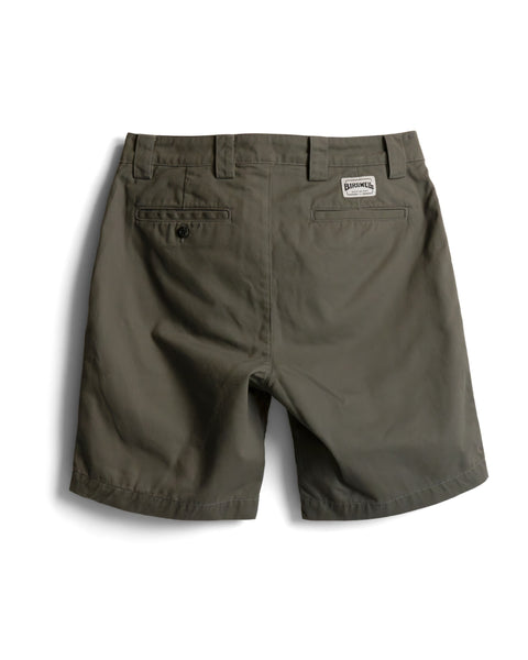 Back view of Stockman Chino Shorts - Moss in olive green cotton twill, featuring two back pockets and a rectangular logo patch above the right pocket.