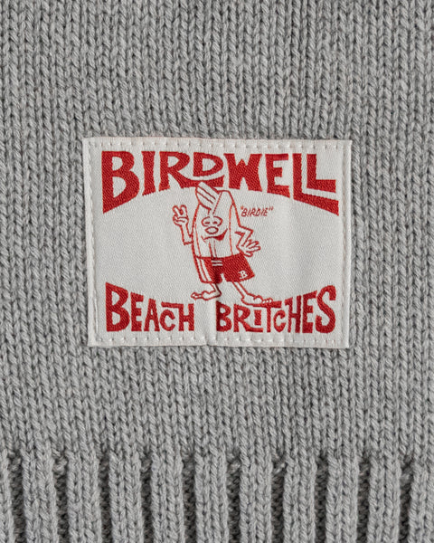 A white fabric label with red text reads BIRDWELL BEACH BRITCHES and shows a cartoon bird in swim trunks on a gray cotton blend background, perfect for pairing with your Racing Cardigan Sweater - Gray/Navy.