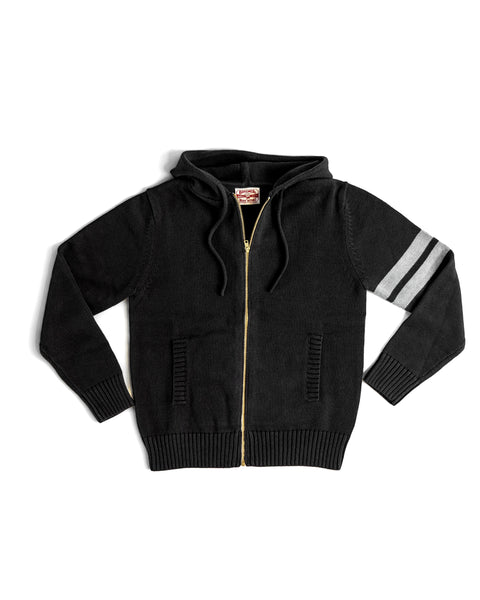 The Comp Zip Sweater - Black/Gray is a midweight knit, 100% cotton sweater with two front pockets and two gray stripes on the left sleeve, shown laid flat on a white background.