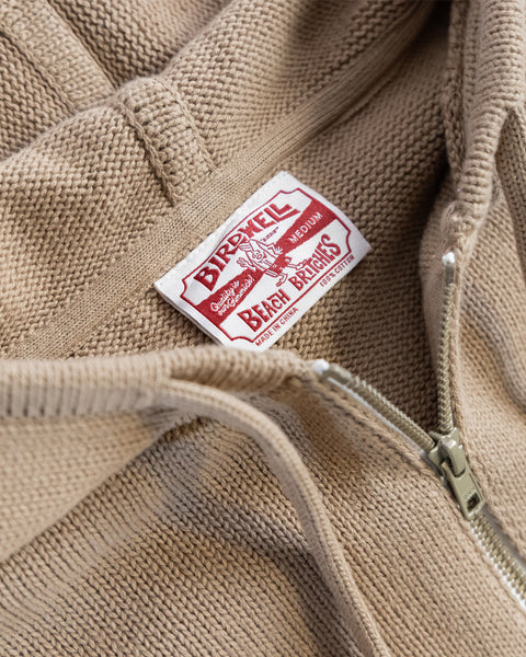 Close-up of the Comp Zip Sweater - Bark/Bone, a midweight knit with a white and red Birdwell Beach Britches Quality Product label sewn inside the collar.