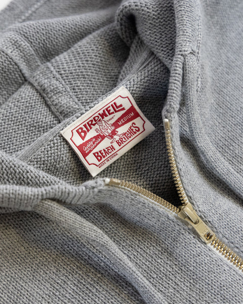 Close-up of the gray/navy Comp Zip Sweater featuring a gold YKK Vislon zipper and a white/red BIRDWELL BEACH BRITCHES MEDIUM label inside the collar.