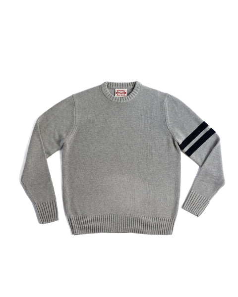 The Comp Stripe Sweater - Gray/Navy is a regular fit, light gray sweater made from a soft cotton blend. It features ribbed cuffs and hem plus two navy horizontal stripes on the left sleeve for timeless style.