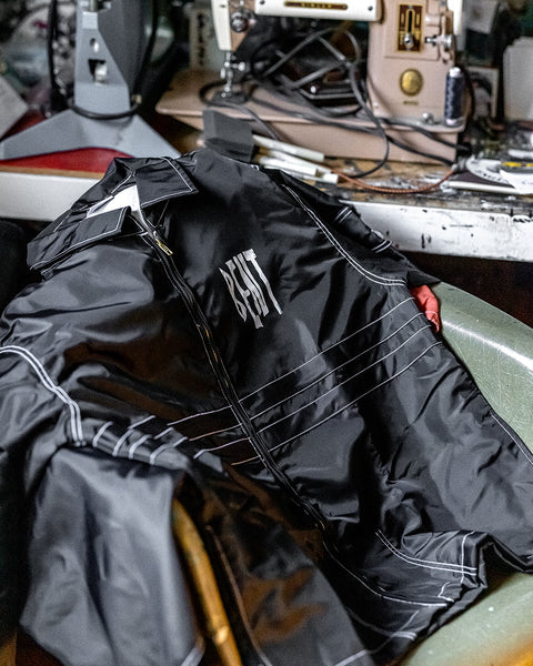 A black BENT Comp Jacket with white stitching and 