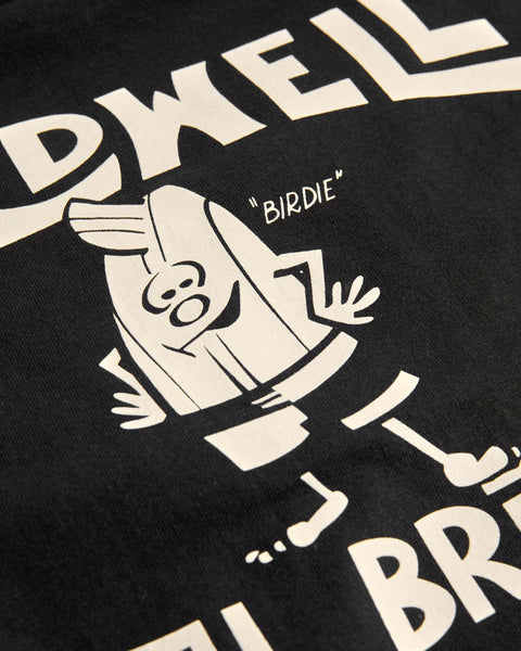 The License Plate T-Shirt - Black/White features Birdie, a cartoon bird with a beak and round eyes, standing with hands on hips amid white text. This vintage heavyweight tee is 100% cotton and made in the USA.