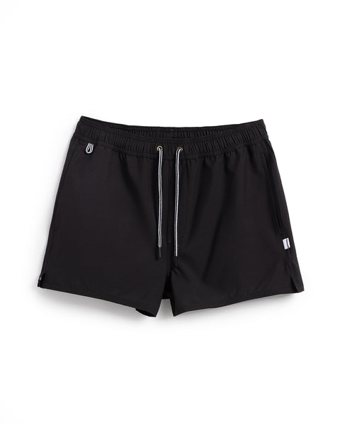 The Women's Wright Short - Black features a drawstring waistband, small logo details, side pockets, and a short length, shown against a white background.