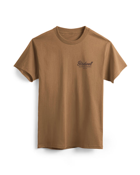 The Daydreamin' Birdie T-Shirt in brown is a relaxed fit, short-sleeve cotton heavyweight tee featuring Birdwell and small black text on the left chest, shown on a white background.